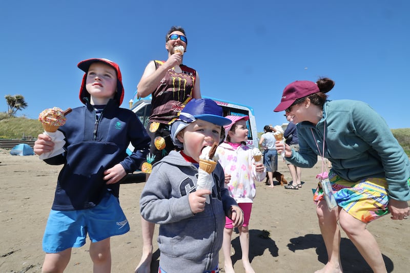 Milo, Brian Óg and Ellie with parents Brian and Sara Moroney from Inchicore on Donabate Beach. Photograph: Alan Betson