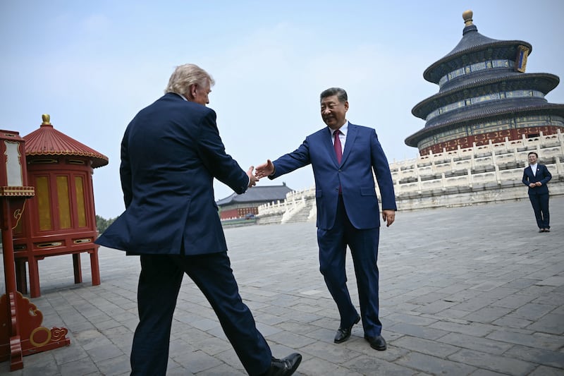 Xi Jinping greets Donald Trump at the Temple of Heaven in Beijing. Photograph: Brendan SMIALOWSKI/AFP via Getty Images