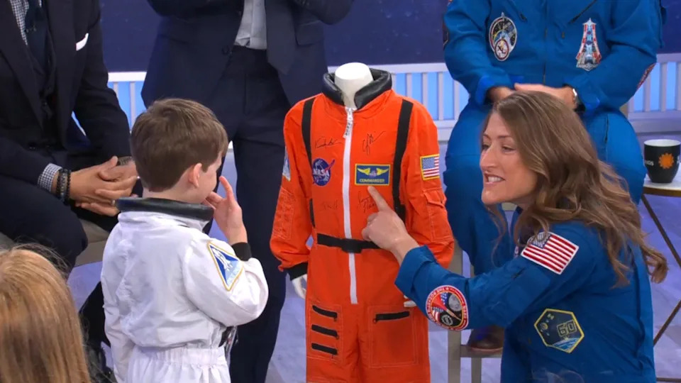 Artemis II mission specialist Christina Koch gives 5-year-old Jack a spacesuit during a CBS News town hall on May 1, 2026. / Credit: CBS News