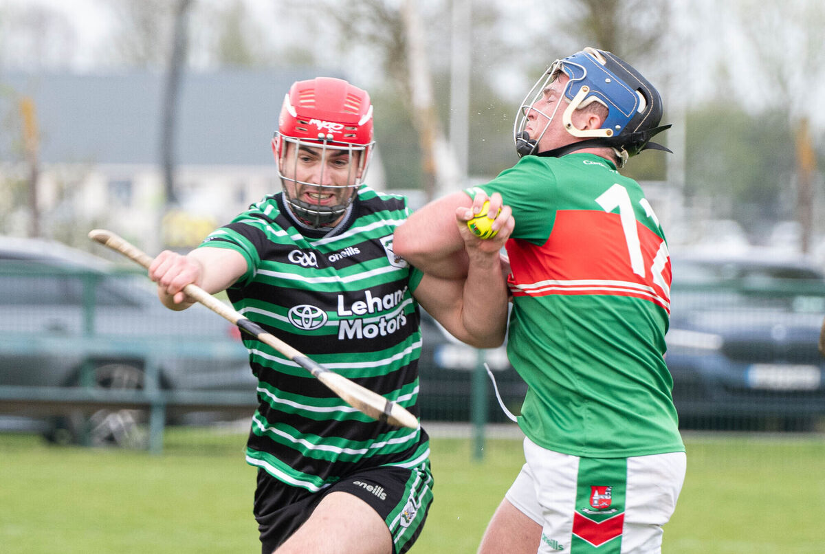 Conor Kingston of Douglas holds off the challenge from Jack Finn of Fr O'Neill's during their Red FM SHL match at Aghavine. Picture: Howard Crowdy
