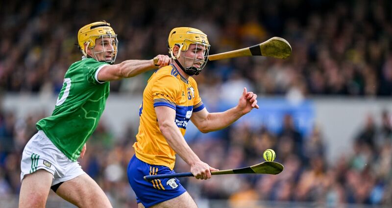 CARRYING THE FIGHT: Mark Rodgers of Clare is tackled by Cathal O'Neill. Photo by Ray McManus/Sportsfile