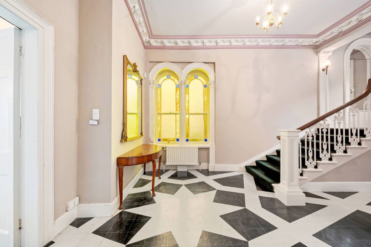 Arched windows overlook the hallway