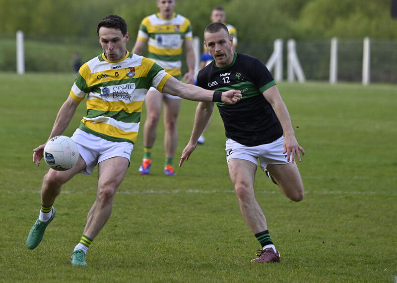 Carbery Rangers' John O'Rourke clears away from Conor Horgan of Nemo Rangers. Picture: Martin Walsh