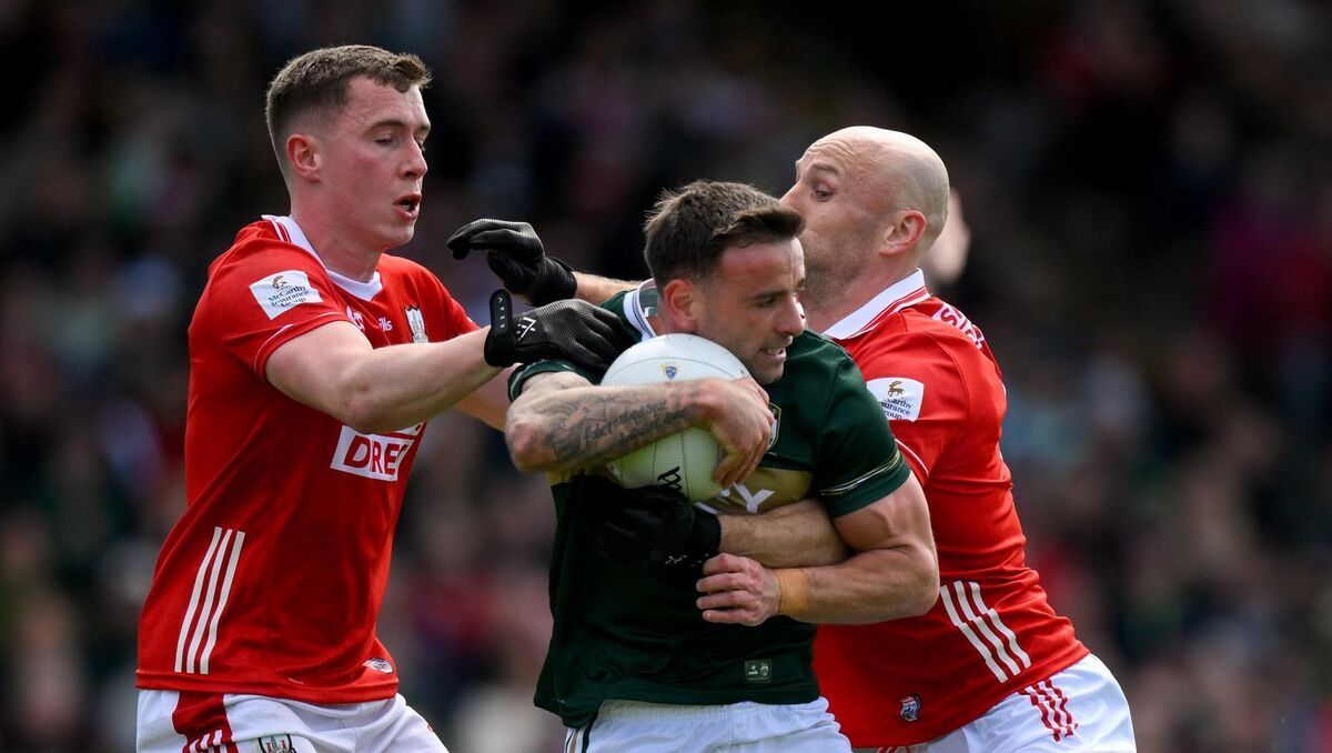 Micheál Burns of Kerry is tackled by Luke Fahy, left, and Brian O’Driscoll of Cork . Photo by Brendan Moran/Sportsfile