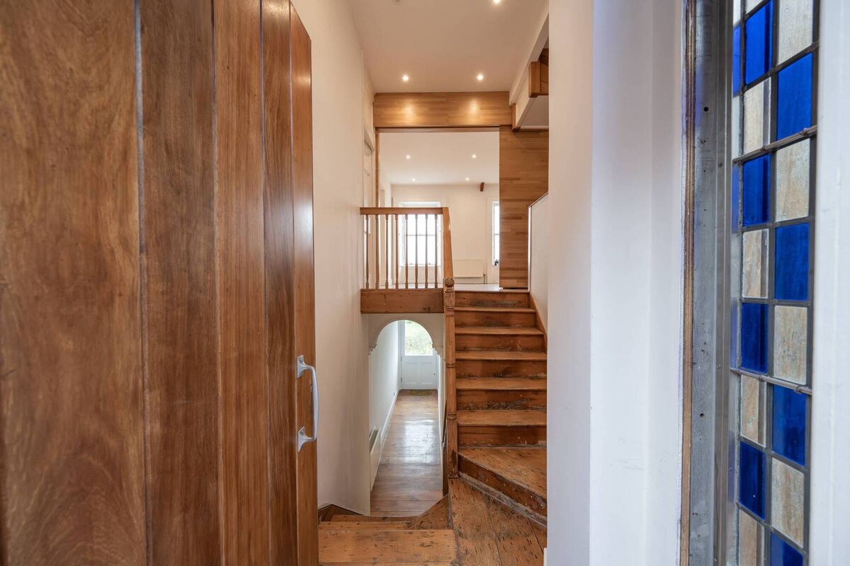 Restored banisters and a glimpse of the feature window with cobalt panes