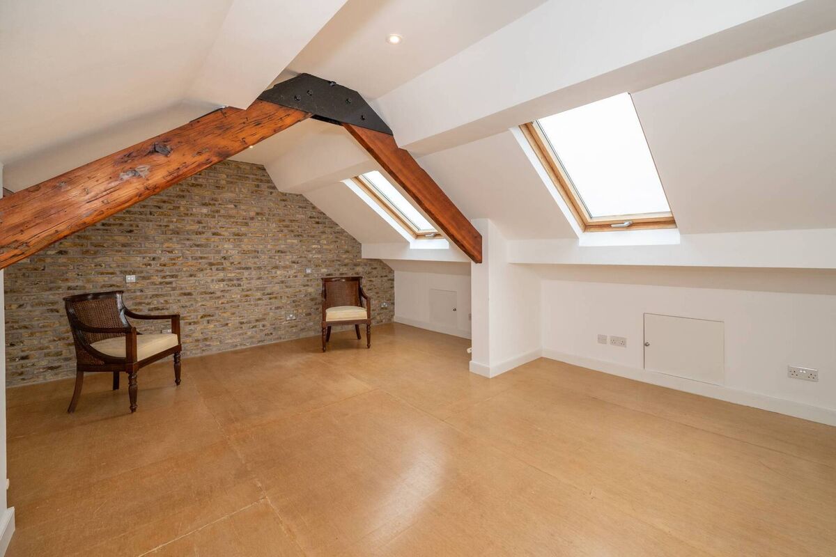 Exposed yellow brick in the double en suite bedroom under the eaves