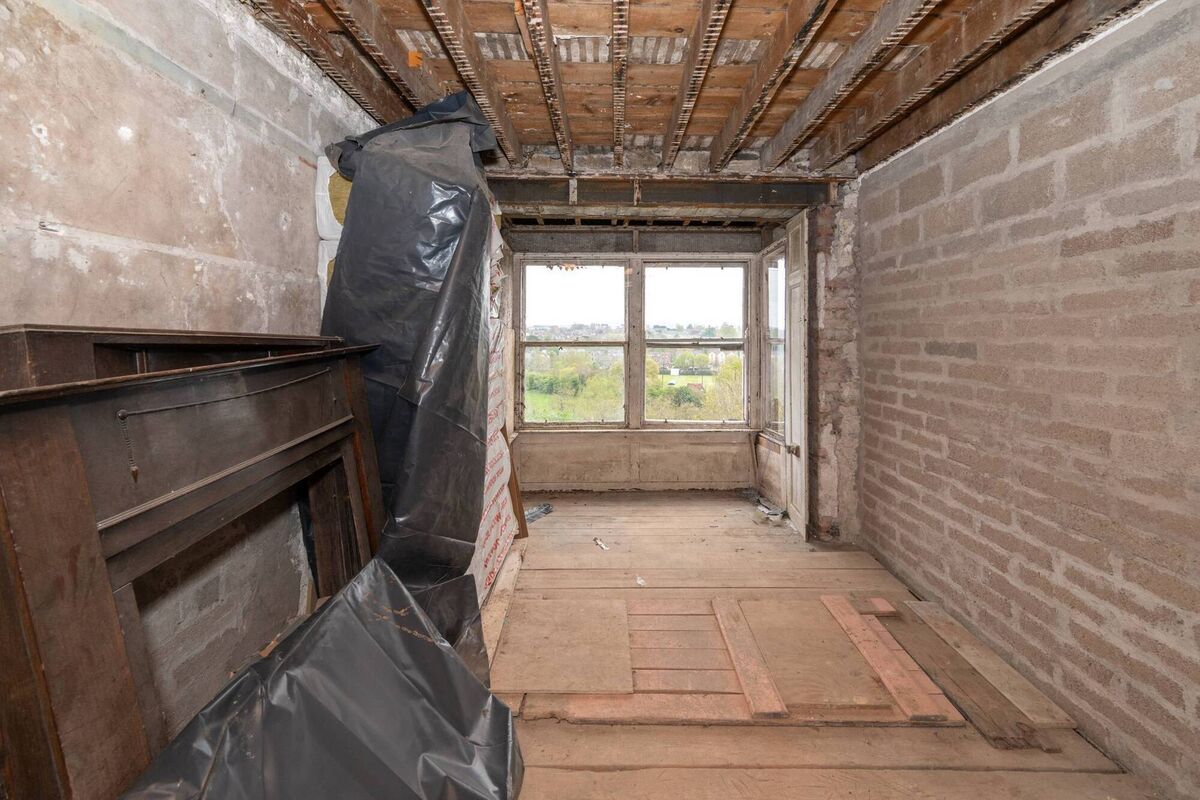 Unfinished upper floor of the apartment with box bay window