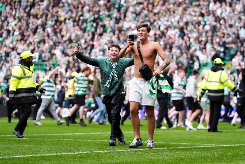 PITCH PERFECT: Celtic fans celebrate their side's victory over Heart of Midlothian following the William Hill Premiership match at Celtic Park, Glasgow. Pic: Andrew Milligan/PA Wire.