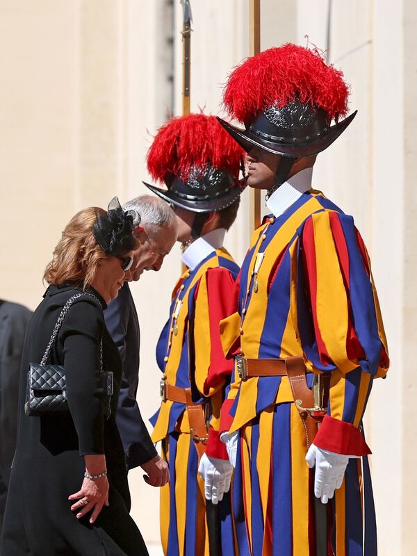 Taoiseach Micheal Martin and his wife Mary O'Shea walk past the Swiss Guards as they arrive in San Damasso Courtyard, Vatican City, ahead of a meeting with Pope Leo XIV. Picture: Liam McBurney/PA