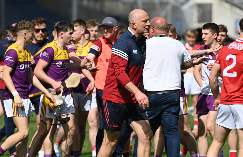 Cork manager Donal Mulcahy (navy cap) calms tensions following the final whistle. Picture: Eddie O'Hare