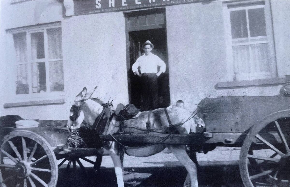 Sheehan’s pub in Whitegate, which had three steps, recalls Micheál Kenefick, and was beside the post office. This was an era when donkeys and carts were the main mode of transport Picture supplied by Micheál Kenefick