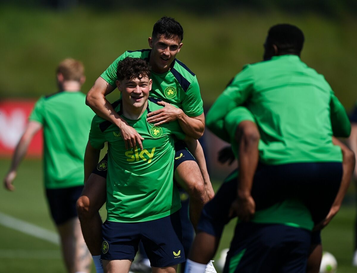 Jamie McGrath is lifted by Owen Elding during an Ireland training session at the FAI National Training Centre. Pic: Stephen McCarthy/Sportsfile