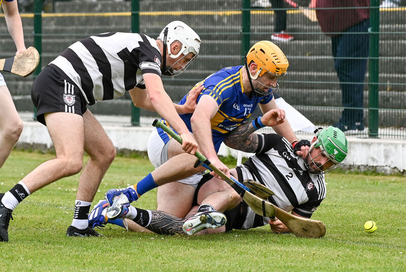 Midleton's Cárthaigh Cronin and Luke Dineen tussle with Carrigtwohill's Liam Sullivan. Picture: David Keane