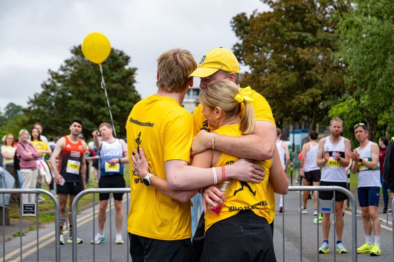 Members of the Cassidy family comfort one another following the release of 24 yellow balloons in memory of Ellen. Picture: Chani Anderson.