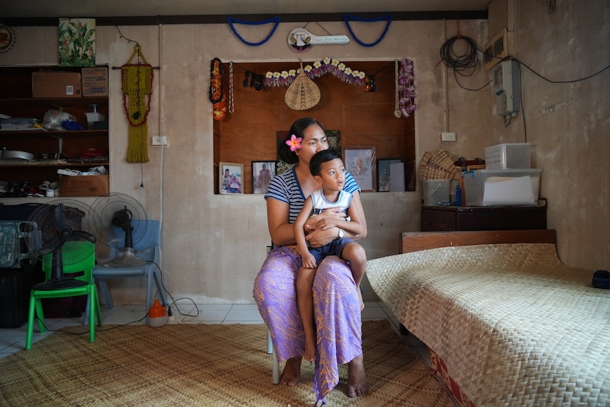 Falepili visa recipient Tevaogali Elisala with her four-year-old son Alfred on her knee.