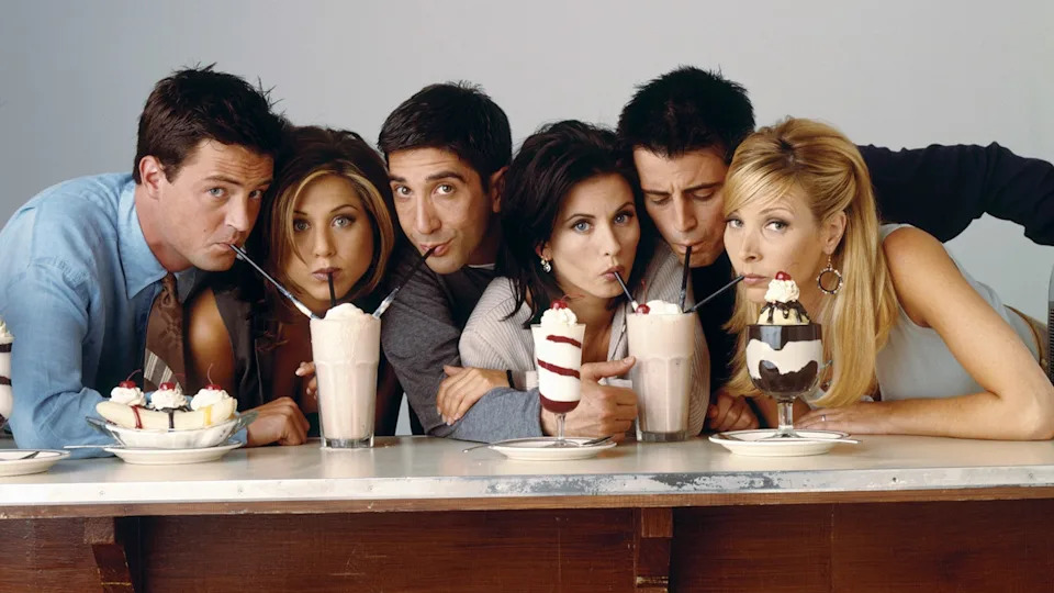 Matthew Perry as Chandler Bing standing with Jennifer Aniston as Rachel Green and David Schwimmer as Ross Geller