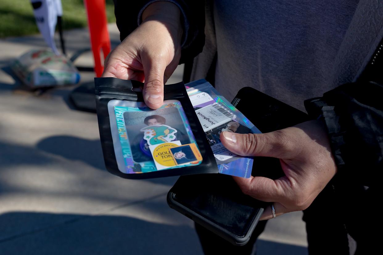 Gina Rodriguez, a fan of BTS for a decade, picks out the merchandise she wants after becoming the first in line to buy merchandise Friday, May 1, 2026, outside the Don Haskins Center in El Paso, Texas. Rodriguez said she had been in line since 3:30 a.m., a day before the band’s first concert.