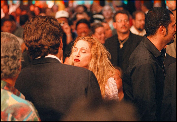 John F. Kennedy Jr. talks to Madonna at the Mike Tyson-Evander Holyfield rematch in 1997.