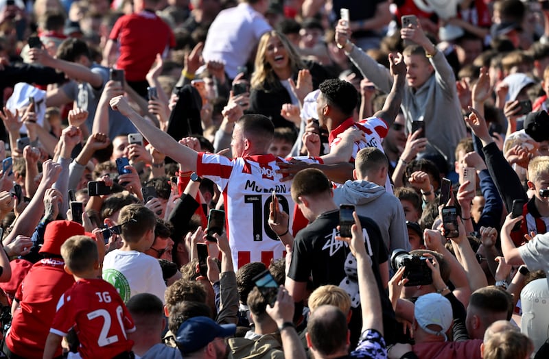 Lincoln City's Jack Moylan (left) and Reeco Hackett celebrate with fans after the League One win over Wycombe Wanderers last month. Photograph: Bruce Rollinson/PA
