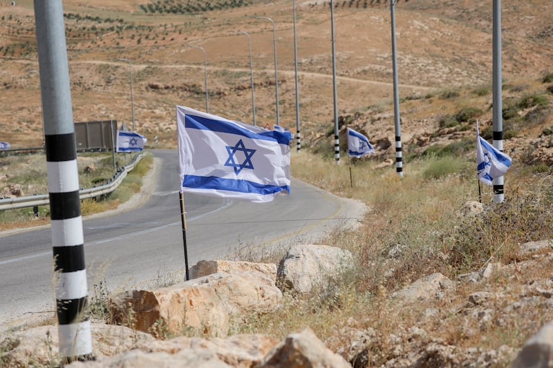 Israeli flags placed along the edge of a road in the village of Umm al-Khair in Masafer Yatta, in the occupied Palestinian West Bank. Photograph: Mosab Shawer/Middle East Images/AFP via Getty