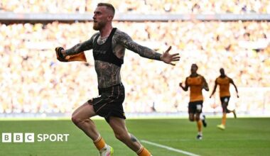 Hull City strike Oli McBurnie with his shirt off, showing a torso and arms covered in tattoos, runs away to celebrate his winning goal against Middlesbrough