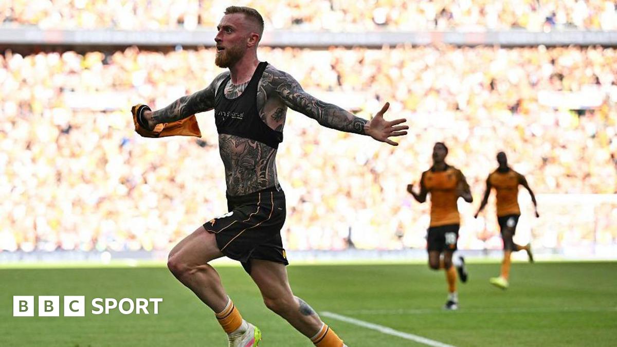 Hull City strike Oli McBurnie with his shirt off, showing a torso and arms covered in tattoos, runs away to celebrate his winning goal against Middlesbrough