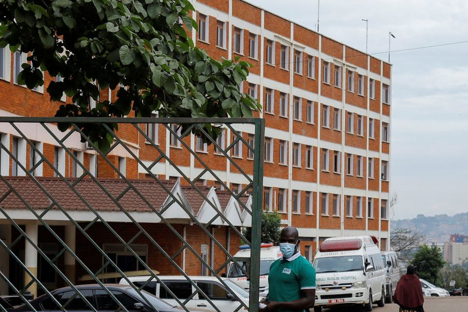 A worker stands guard at the gate of the Kibuli Muslim Hospital where a Congolese man died of Ebola Bundibugyo virus in Kibuli suburb of Kampala, Uganda May 16, 2026. REUTERS/Abubaker Lubowa