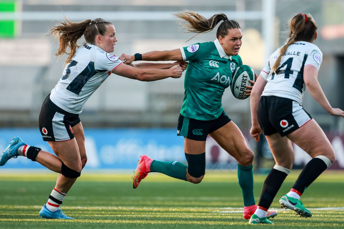 Ireland's Béibhinn Parsons hands off Carys Cox of Wales