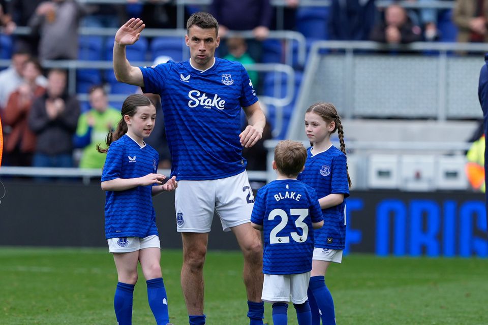 Everton's Seamus Coleman with his children on the pitch after the match