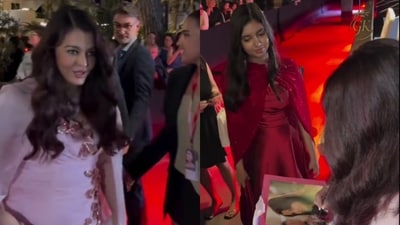 Aaradhya Bachchan smiles proudly as mom Aishwarya Rai signs autographs for fans.