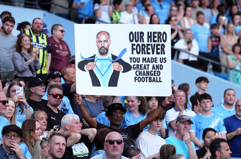 A City fan holds a sign thanking Pep Guardiola at the Etihad Stadium in Manchester on Sunday. Photograph: Martin Rickett/PA Wire