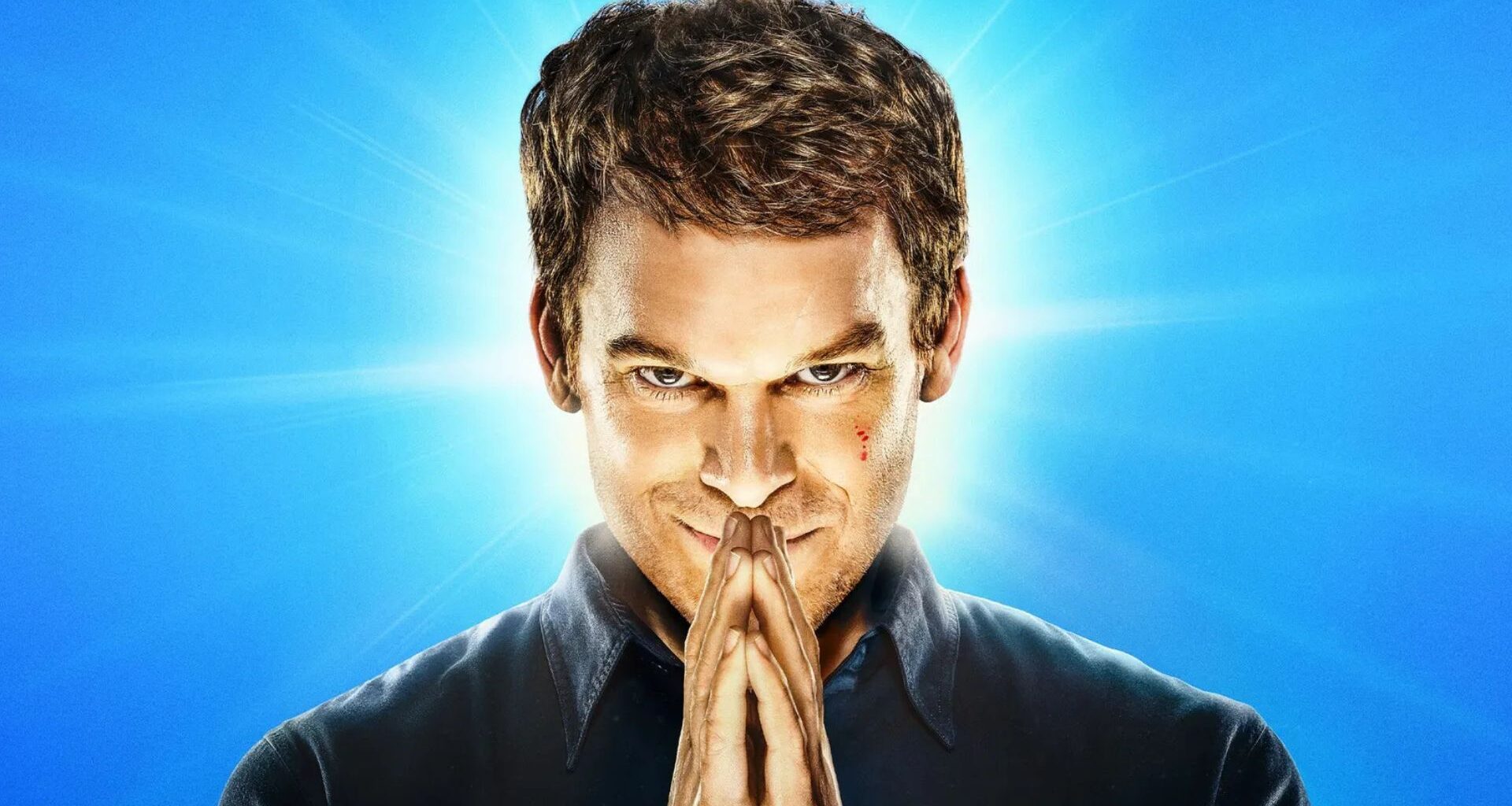 Dexter puts his hands together in a prayer position in front of his face