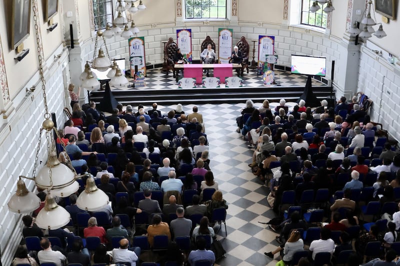 Gopalkrishna Gandhi, seated right at table, addresses the audience at the Jaipur International Festival in Trinity College