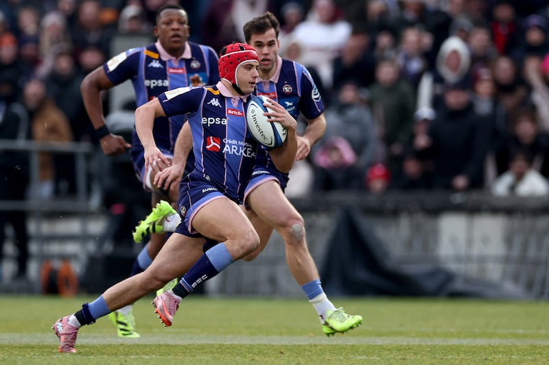 Bordeaux's Louis Bielle-Biarrey runs with the ball as Cameron Woki and Damian Penaud look on in victory over Northampton Saints. Photograph: Romain Perrocheau/AFP via Getty Images