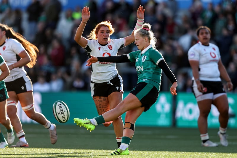 Wales' Georgia Evans attempts to block a kick from Ireland's Dannah O’Brien. Photograph: Inpho