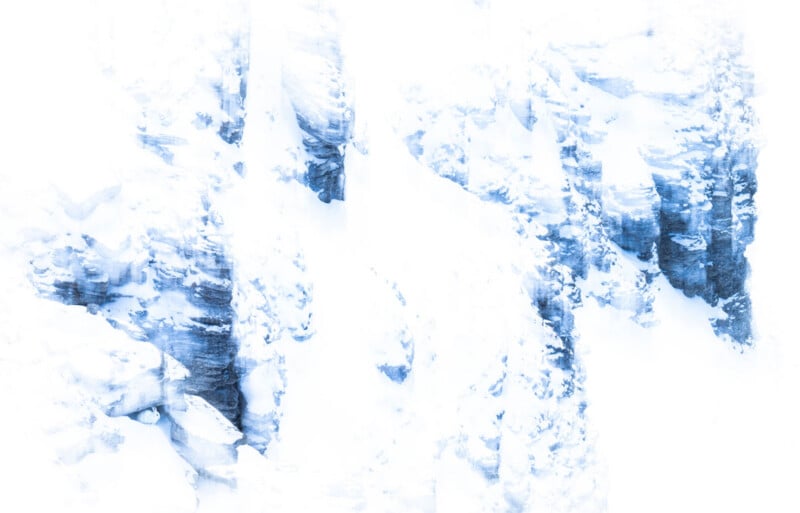 High-contrast, abstract image of icy, snow-covered rock formations with shades of blue and white, giving a cold, wintry atmosphere and minimalistic appearance.
