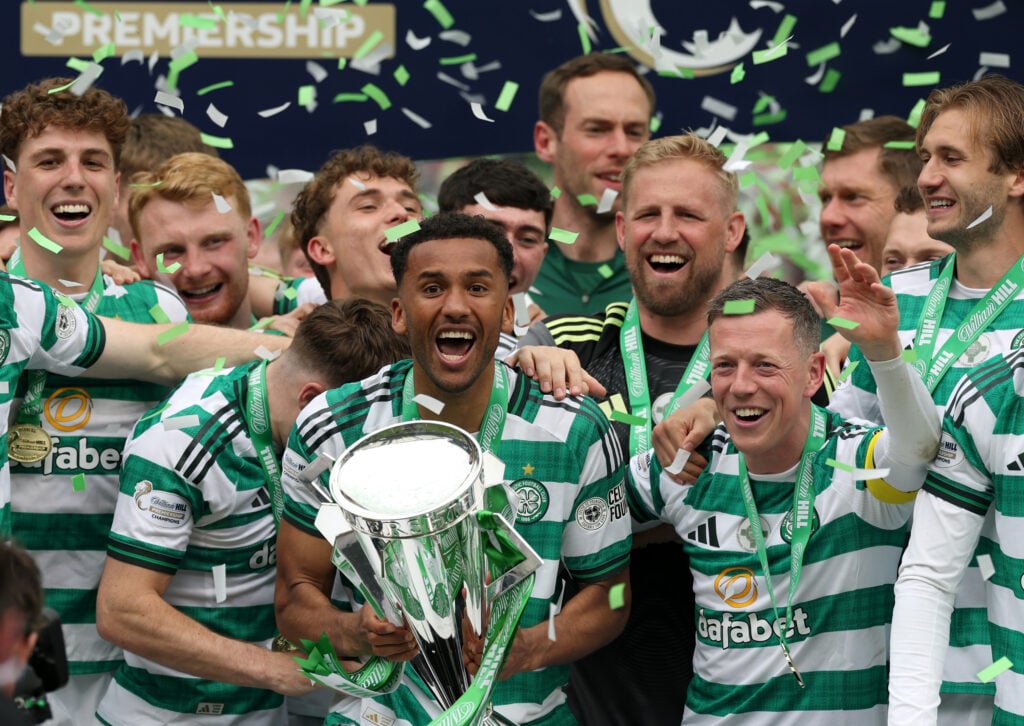 Auston Trusty of Celtic lifts the William Hill Premiership Trophy with teammates following the team's victory in the William Hill Premiership match between Celtic and Heart of Midlothian