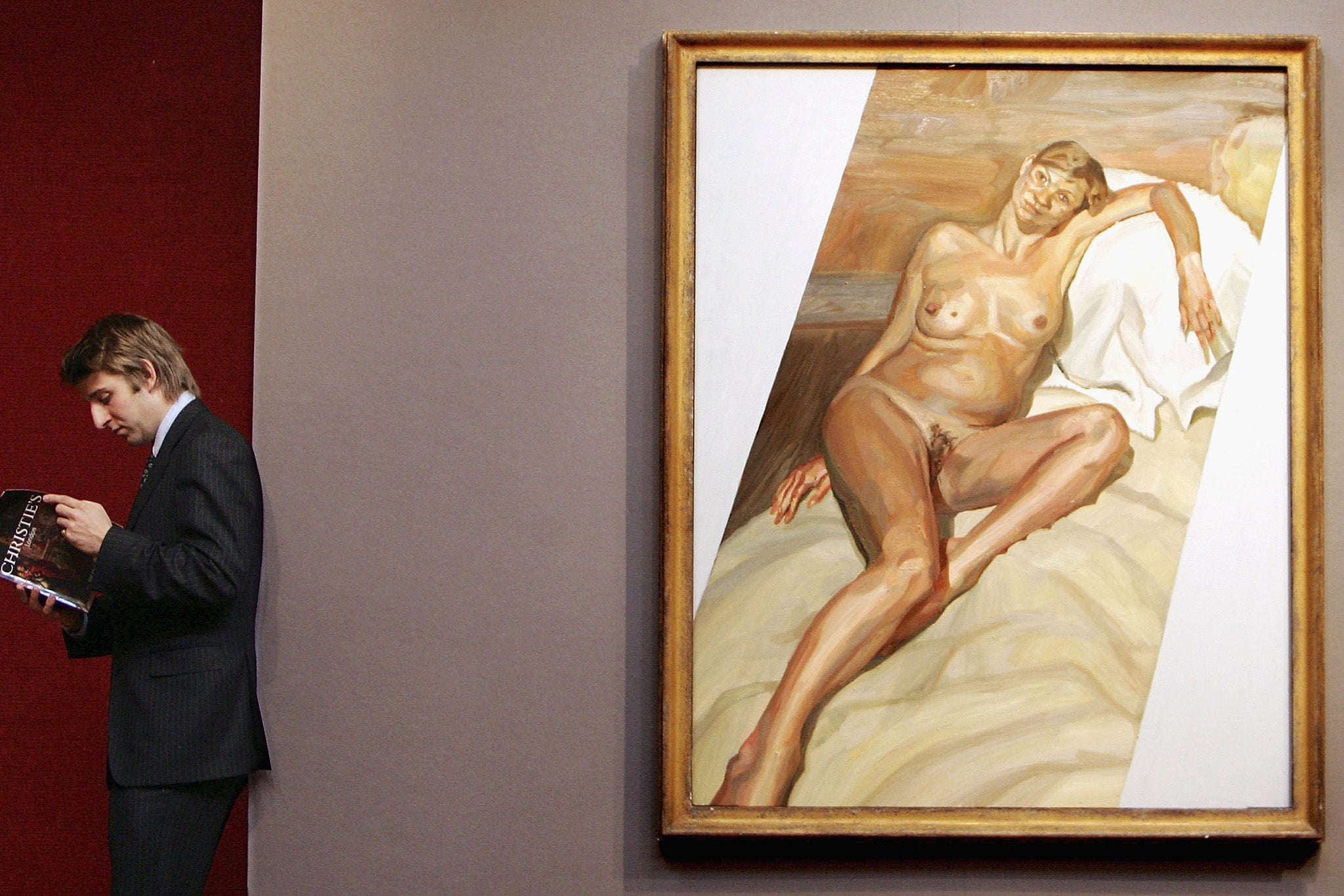 A Christies auctioneer stands near the finished ‘Naked Portrait 2002’ in 2004