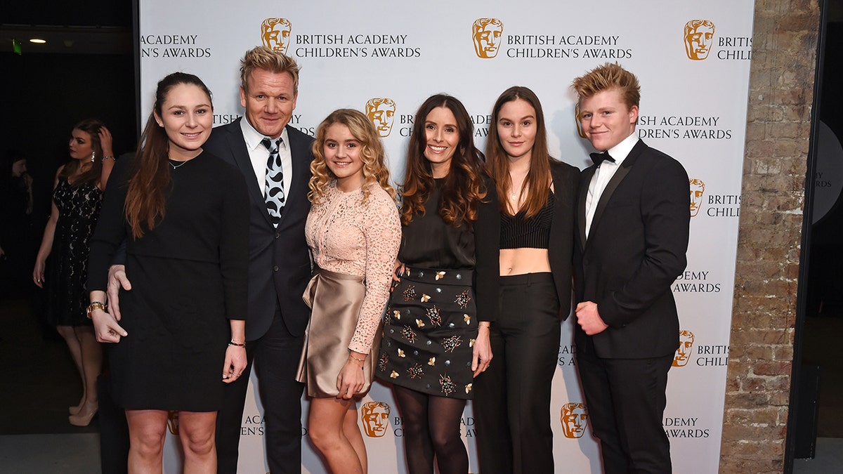 Gordon Ramsay standing with his children Megan, Matilda, Tana, Holly, and Jack Ramsay at an event
