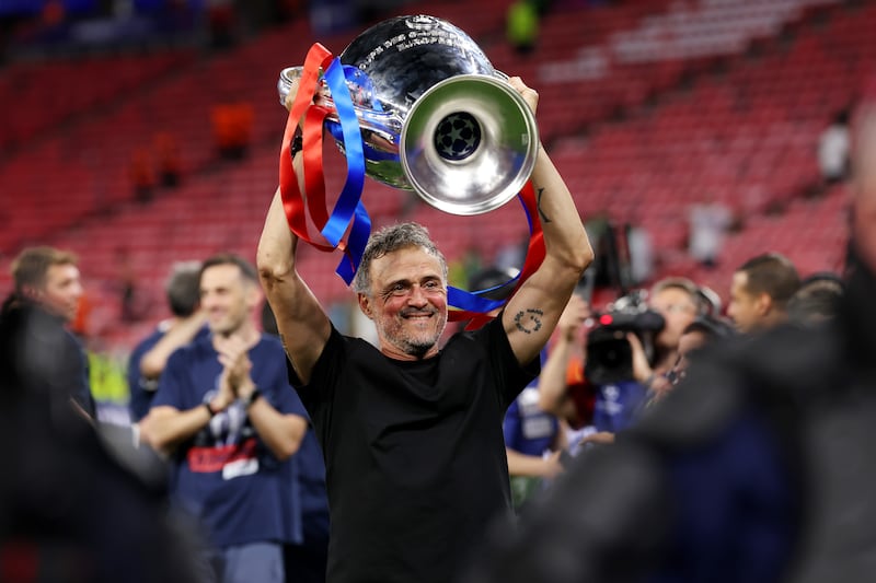 PSG head coach Luis Enrique celebrates with the Champions League trophy. Photograph: Carl Recine/Getty Images
