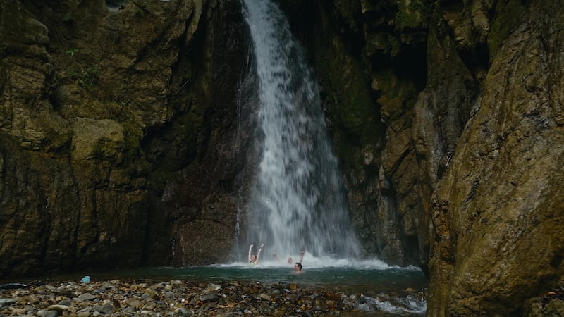 Ciara Mageean, Ray Goggins and Michael Darragh MacAuley swim under a waterfall in Costa Rica.