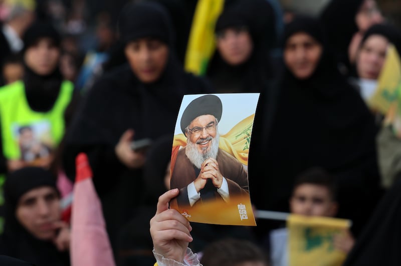 A Hizbullah supporter carries a picture of the group's late Hllah leader Hassan Nasrallah during a gathering to mark Resistance and Liberation Day in the al-Kafaat neighborhood of Beirut's southern suburbs, Lebanon. The gathering commemorates the  withdrawal of the Israeli military from southern Lebanon on May 25th, 2000, ending a 22-year occupation. Photograph: Wael Hamzeh/EPA