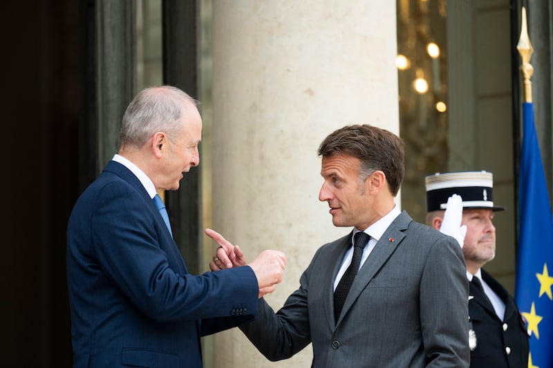 French president Emmanuel Macron (right) welcomes Taoiseach Micheál Martin ahead of their meeting at the Elysee Palace in Paris on Thursday. Photograph: Magali Cohen/Hans Lucas/AFP via Getty Images