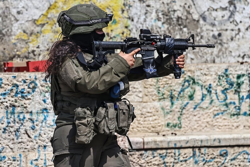 An Israeli security force member patrols during a military raid at the Qalandia refugee camp, south of the city of Ramallah, in the Israeli-occupied West Bank, on Wednesday. Photograph: Zain Jaafar/AFP via Getty Images