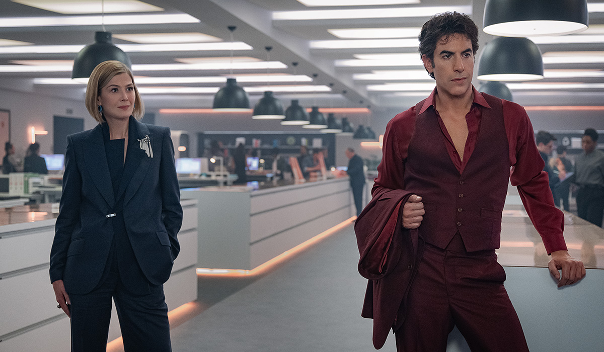 Ladies First. (L-R) Rosamund Pike as Alex Fox and Sacha Baron Cohen as Damien Sachs in Ladies First. Cr. Rob Youngson/Netflix © 2026.