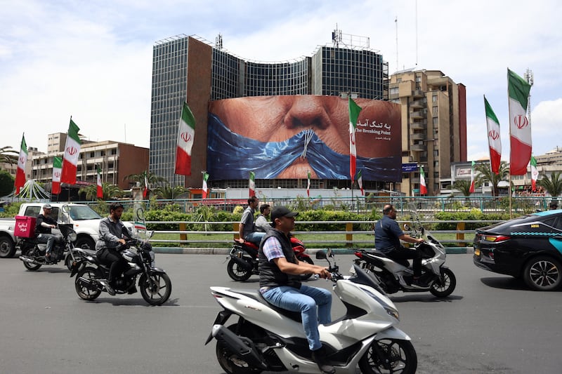 People drive near an anti-US billboard with an image depicting US president Donald Trump at Valiasr square in Tehran, Iran, on Wednesday. Photograph: Abedin Taherkenareh/EPA