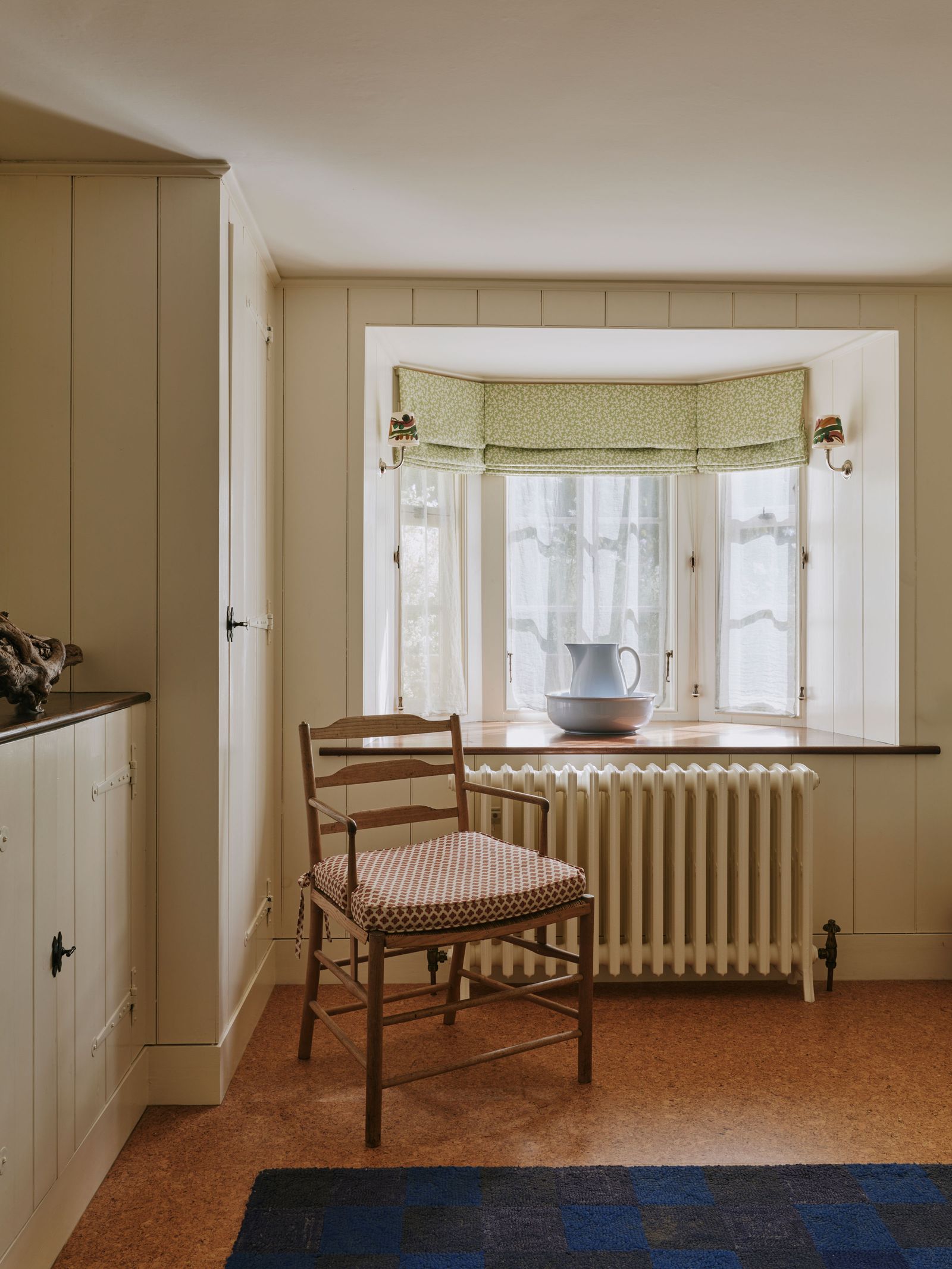 Image may contain Chair Furniture Home Decor Rug Window Bay Window Indoors and Interior Design