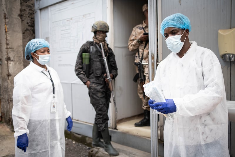 Staff in protective gowns distribute facemaskes in Goma, North Kivu, Democratic Republic of the Congo. Photograph: EPA