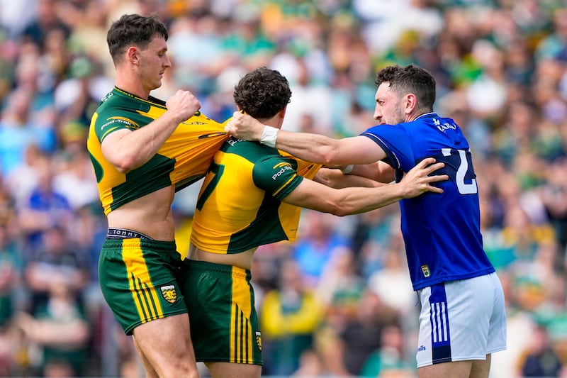 Paudie Clifford of Kerry holds onto Finbarr Roarty and Michael Langan of Donegal during the All-Ireland SFC Round 1 game at Fitzgerald Stadium, Killarney. Photograph: James Lawlor/Inpho