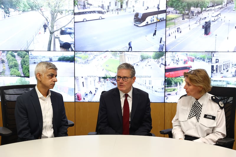 UK prime minister Keir Starmer (centre) and mayor of London Sadiq Khan speak with Metropolitan Police commander Clair Haynes  during a visit to a police station in Lambeth, south London, on Friday. Photograph: Peter Nicholls/PA Wire